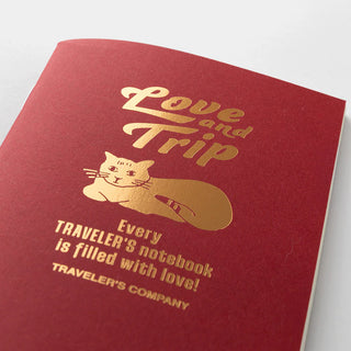 Traveler's notebook passport refill cover in red with gold "Love and Trip" cat graphic