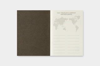 Open passport-sized stamp refill insert: dark brown cover and white partner shops form