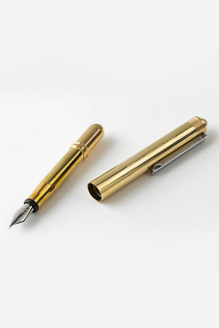Brass fountain pen fine nib close-up with cap off and metal barrel