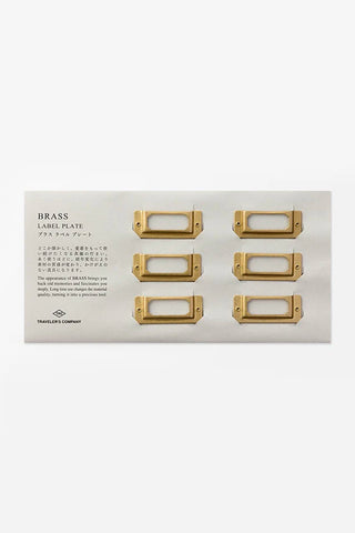 Brass label plate set with six rectangular blank nameplate frames on white card