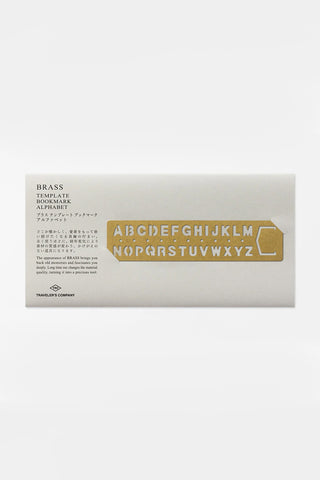 Brass alphabet template bookmark with cutout letters A–Z and decorative frame