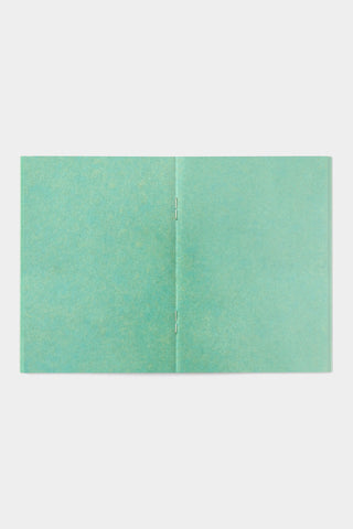 Turquoise kraft passport-size notebook opened flat, two-panel cover