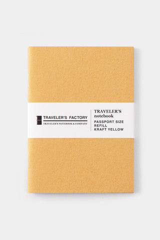 Yellow kraft passport-size notebook cover with Traveler's Factory label