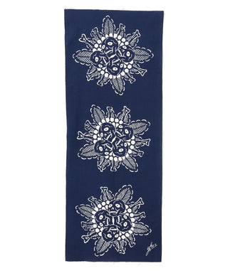 Navy blue tenugui towel with three white patterned creature floral motifs