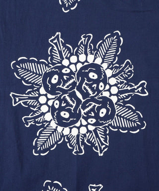 Dark blue tenugui towel close-up of central white creature floral emblem