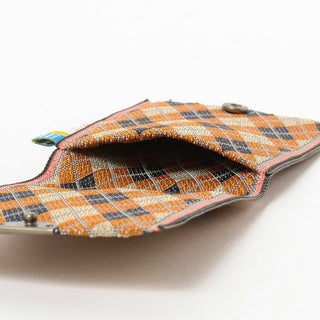 Open-top coin purse with orange-and-cream argyle fabric and dark fabric interior
