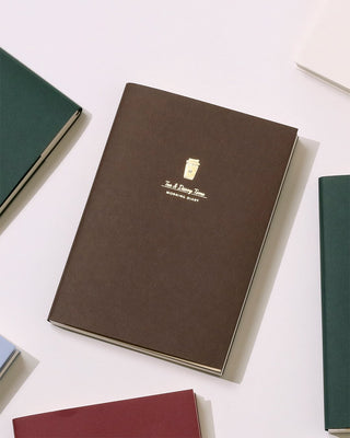 Coffee brown A6 diary, closed with gold crest logo on front cover