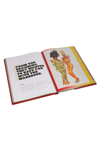 Open art book with printed text pages and fashion illustration on red and yellow background