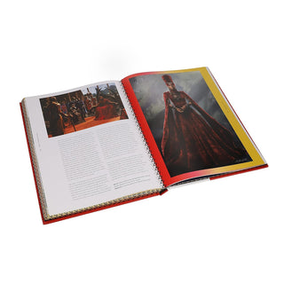 Open art book with two printed pages and a full-page costume portrait photo