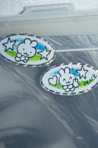 Oval holographic character stickers with stars and “PEACE” text