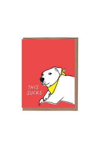 Red greeting card with Snoopy-style dog wearing yellow collar, 'THIS SUCKS' text
