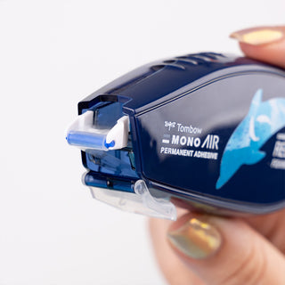Blue glue tape dispenser labeled Tombow MONO AIR permanent adhesive, side view