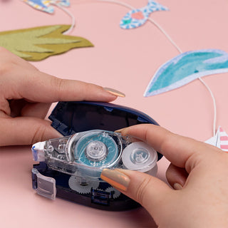Refill cartridge clicked into a clear-and-blue glue tape applicator