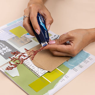 Hands using MONO Air tape applicator to attach paper pieces