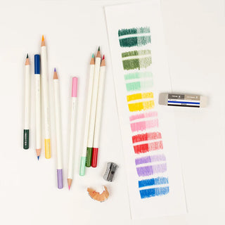 Sand and rubber eraser with blue label beside colored pencils and markers