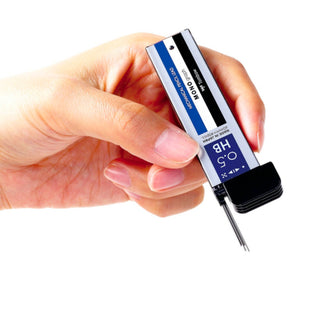Hand holding Tombow MONO 0.5 mm HB pencil lead refills with metal lead pieces