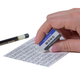 Tombow MONO medium plastic eraser used on paper, held in hand