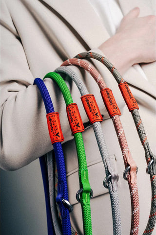 Assorted rope loop straps in red, blue, green, and grey colors with red tags