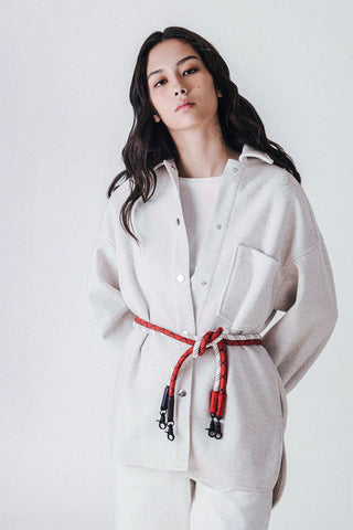 Light rope strap with red ends and metal clips on a crossbody bag