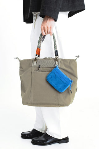 Truffle lattice wrist strap on tote bag handles with brass clips