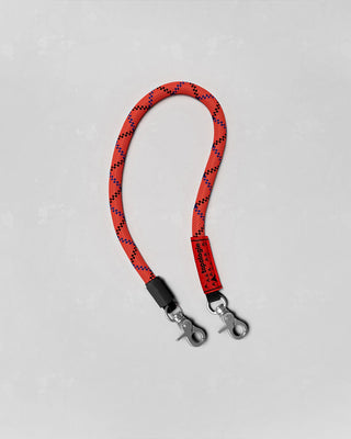 Red and black speckled wrist strap with metal clips and clasp hardware