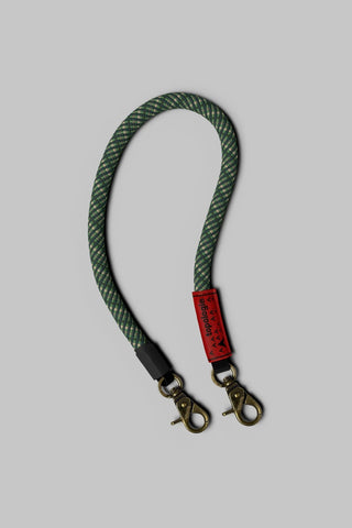 Rifle green lattice wrist strap with red label and two metal snap clasps