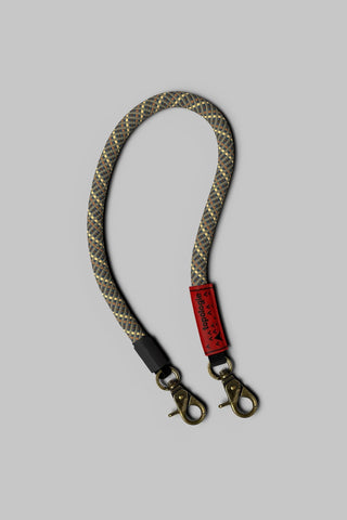 Truffle lattice wrist strap with brass clips and black leather ends