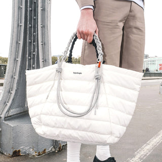 Light grey braided rope strap handles with metal rings on white puffer bag