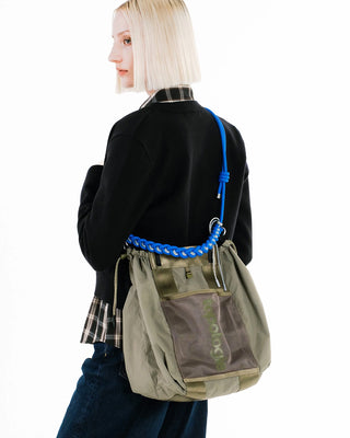 Blue braided O-rope strap looped over back of olive tote bag