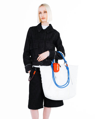 Blue braided O-rope strap with white tote bag and small orange pouch