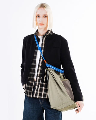 Blue braided O-rope strap on an olive tote bag with metal ring hardware