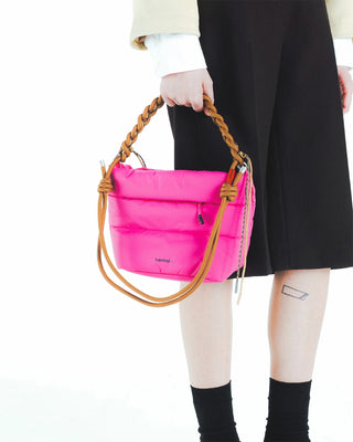 Tan braided rope O-ring strap with leather ends, worn on a hot pink mini bag