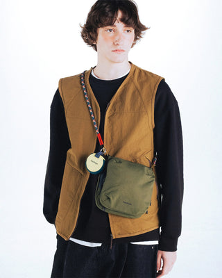 Multicolor helix rope strap on an olive small crossbody bag