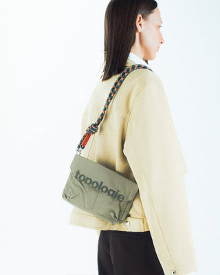 Multicolor helix rope strap worn on a small crossbody bag