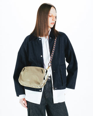 Multicolor helix rope strap on a beige small crossbody bag