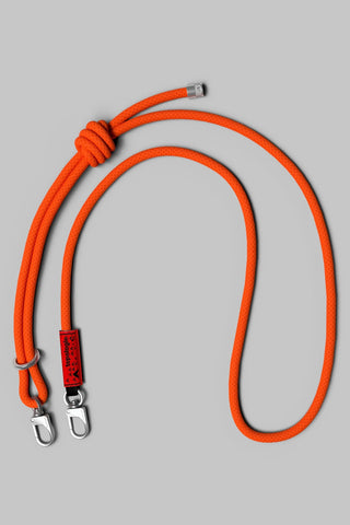 Topologie 8mm rope strap in persimmon orange with two metal clasps and label.