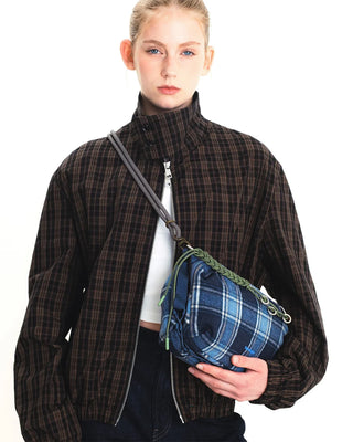 Monochrome rope strap with lattice texture and metal clips, worn across shoulder
