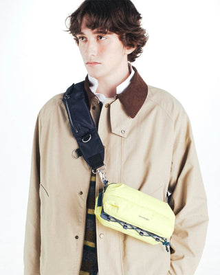 Topologie bomber strap worn across chest with dark pouch and adjustable strap hardware