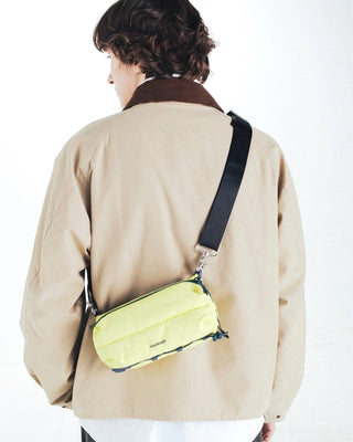 Topologie bomber strap on back view with dark strap and neon-green zippered pouch