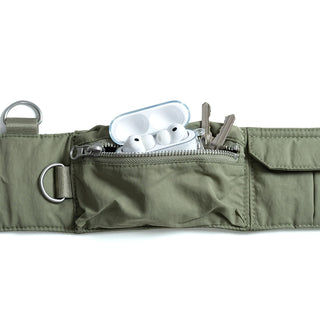 Topologie bomber strap pouch open with white AirPods case, keys, and zipper closure