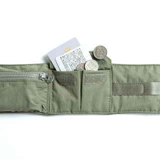 Topologie bomber strap pouch close-up with snap flap, zipper, and rectangular patch