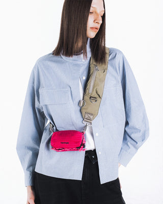 Olive crossbody bomber strap with adjustable webbing and small red pouch