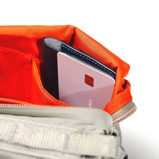 Topologie bottle sacoche interior close-up with red lining and a card holder