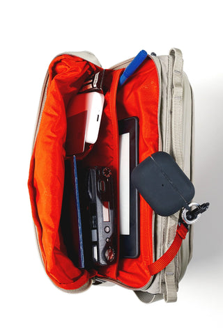 Topologie large bottle sacoche with open red interior and zip compartments