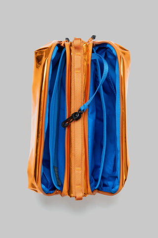 Orange mirror metallic bottle pouch with blue interior, open top and orange webbing