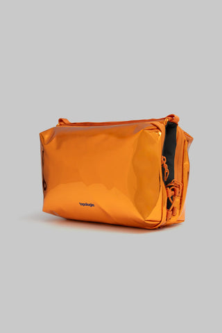 Orange mirror metallic bottle pouch with shoulder strap, side view with draw cords