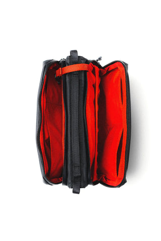 Bottle sacoche with bright red interior lining and black zip divider