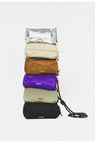 Topologie bottle sacoche bags in multiple colors, shown stacked with straps