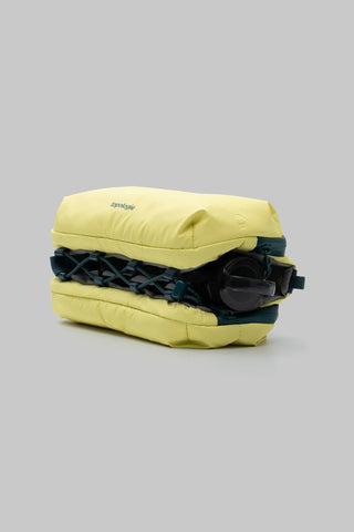 Canary yellow sling bag with elastic front panel and stacked storage