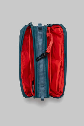 Topologie medium bottle sacoche, deep teal with open red-lined interior and zipper